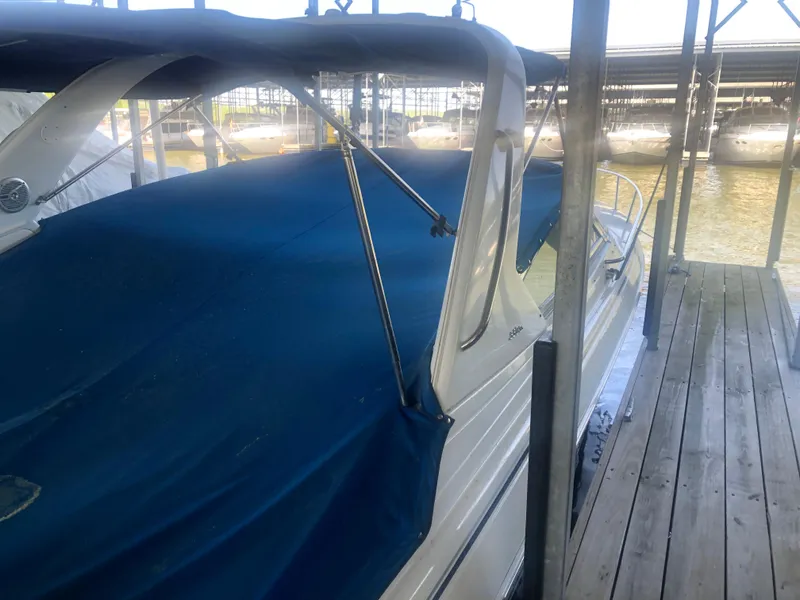 Slide: The Image of 2004 Formula 330 Sun Sport boat docked with blue cover in marina. - 10
