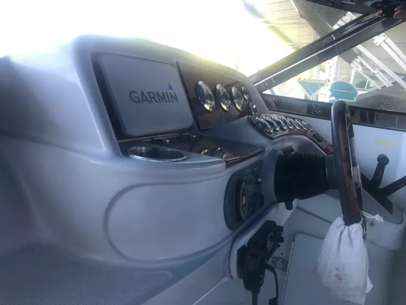 Slide: The Image of 2004 Formula 330 Sun Sport boat interior with white and blue seating. - 23