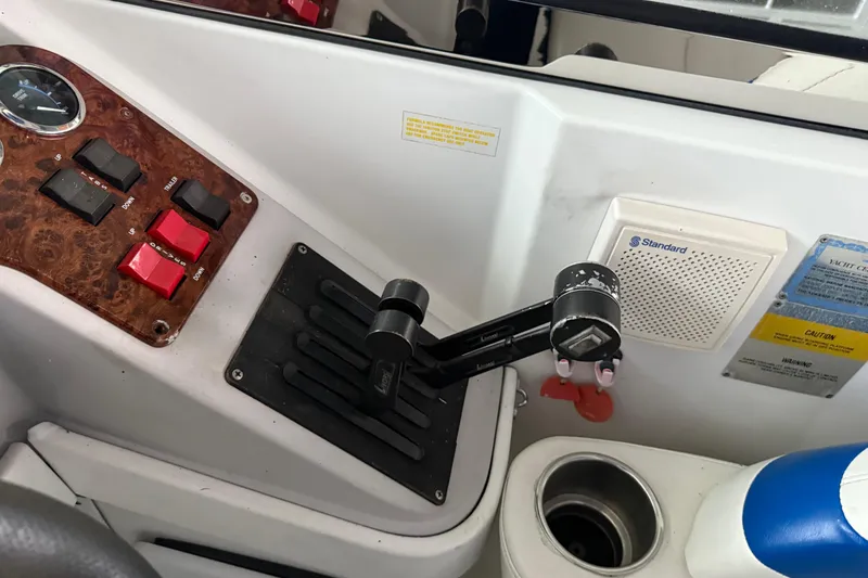 Slide: The Image of Control panel of a 2004 Formula 330 Sun Sport boat with switches and throttle lever. - 46