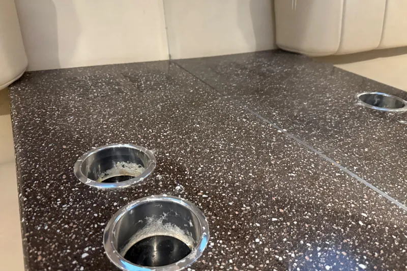 Slide: The Image of Dark speckled countertop with cup holders on a 2004 Formula 330 Sun Sport boat. - 52