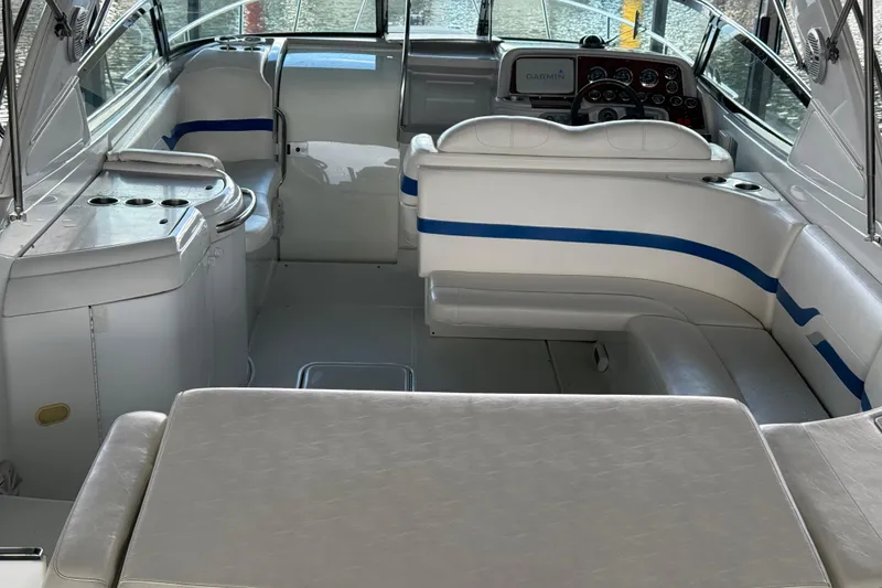 Slide: The Image of 2004 Formula 330 Sun Sport boat interior with white seating and blue accents. - 55