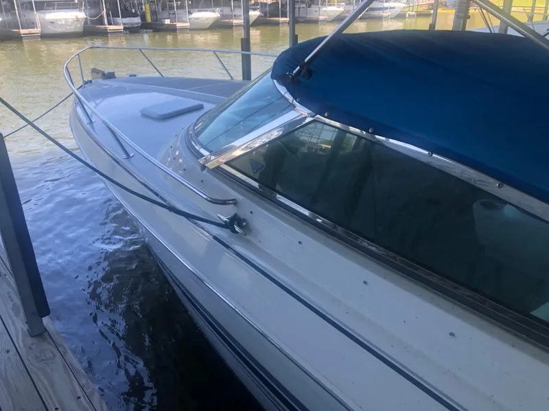 Slide: The Image of 2004 Formula 330 Sun Sport boat docked under a covered marina. - 6