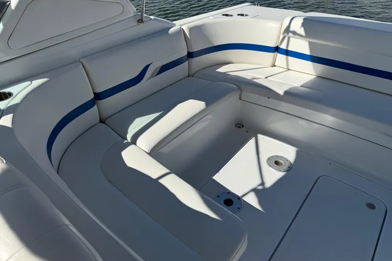 Slide: The Image of 2004 Formula 330 Sun Sport boat interior with white and blue seating. - 63