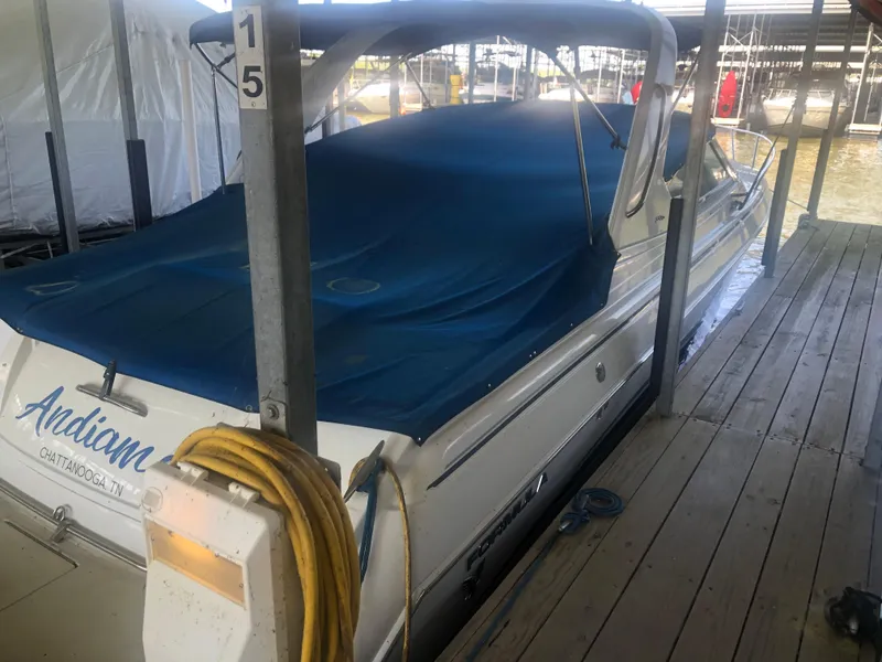 Slide: The Image of 2004 Formula 330 Sun Sport boat with blue canopy docked in marina. - 9