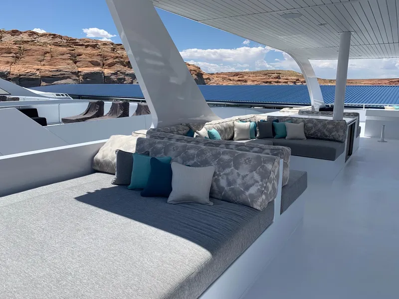 Slide: The Image of Luxurious 2019 Adonia Athena yacht deck with plush seating and scenic views. - 16