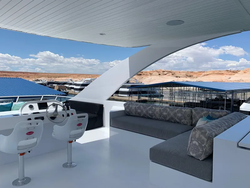 Slide: The Image of Luxurious 2019 Adonia Athena yacht deck with seating and helm, overlooking marina. - 18