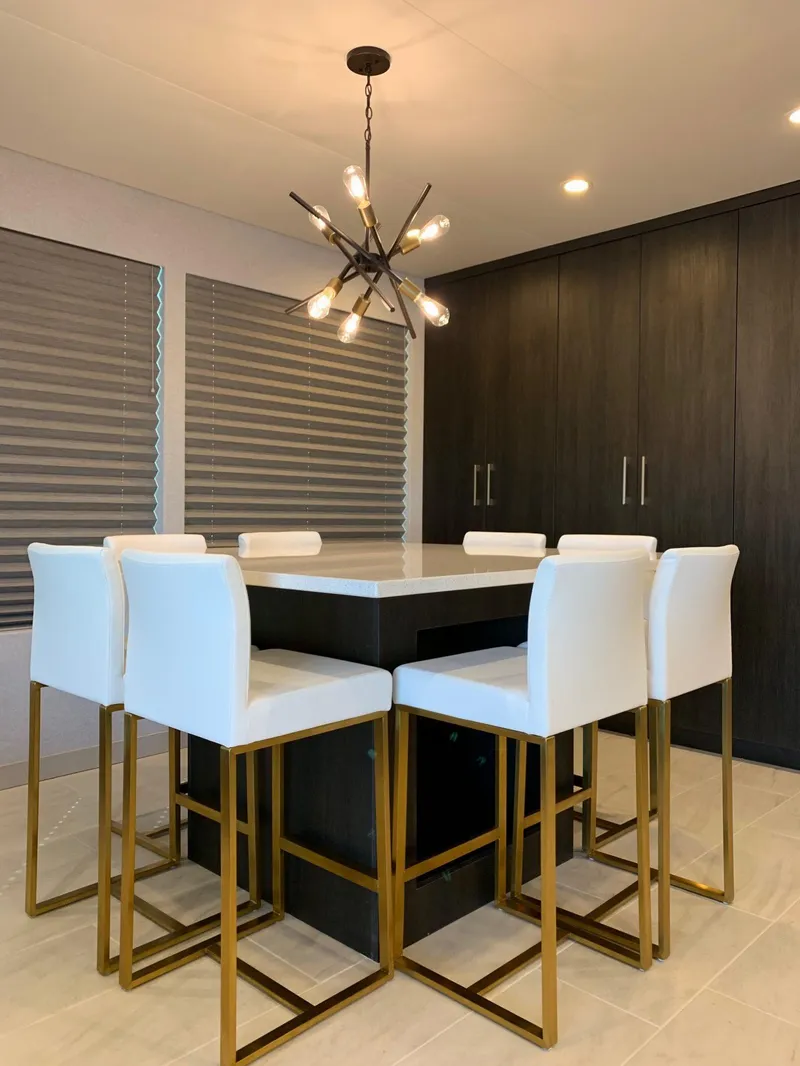 Slide: The Image of Modern dining area with white chairs, dark table, and stylish chandelier, Adonia Athena share #2, 2019. - 3