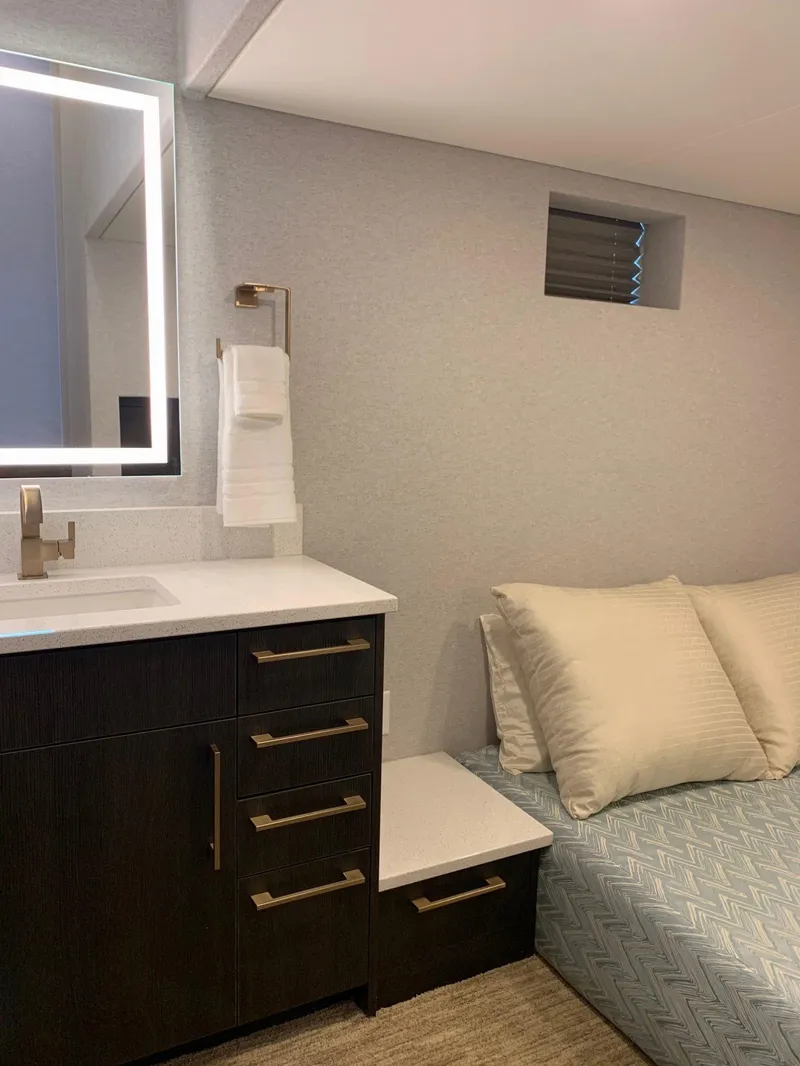 Slide: The Image of Modern bathroom with illuminated mirror, dark vanity, and cozy bed, Adonia Athena share #2, 2019. - 5
