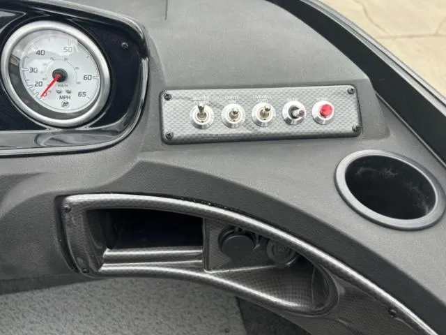 Slide: The Image of 2024 Crestliner HAWK 1650 dashboard with speedometer, switches, and cup holder. - 10