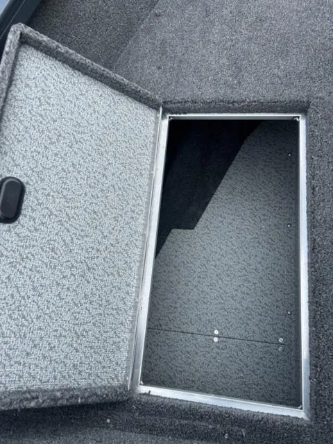 Slide: The Image of 2024 Crestliner HAWK 1650 boat storage compartment with open hatch. - 14