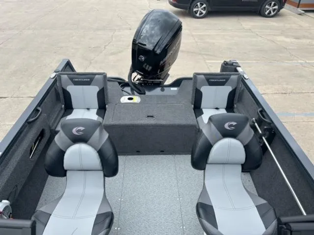 Slide: The Image of 2024 Crestliner HAWK 1650 boat interior with seating and motor. - 17