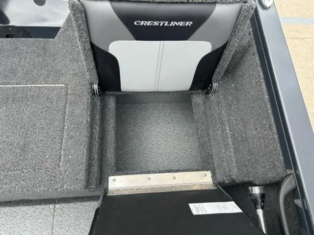 Slide: The Image of 2024 Crestliner HAWK 1650 boat interior with cushioned seat and carpeted flooring. - 18