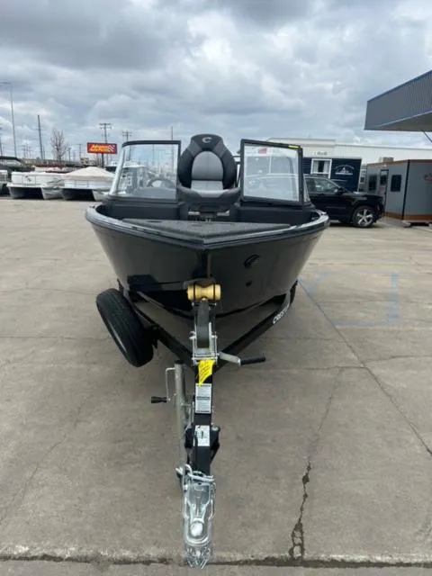 Slide: The Image of 2024 Crestliner HAWK 1650 boat on trailer, parked outdoors under cloudy sky. - 7
