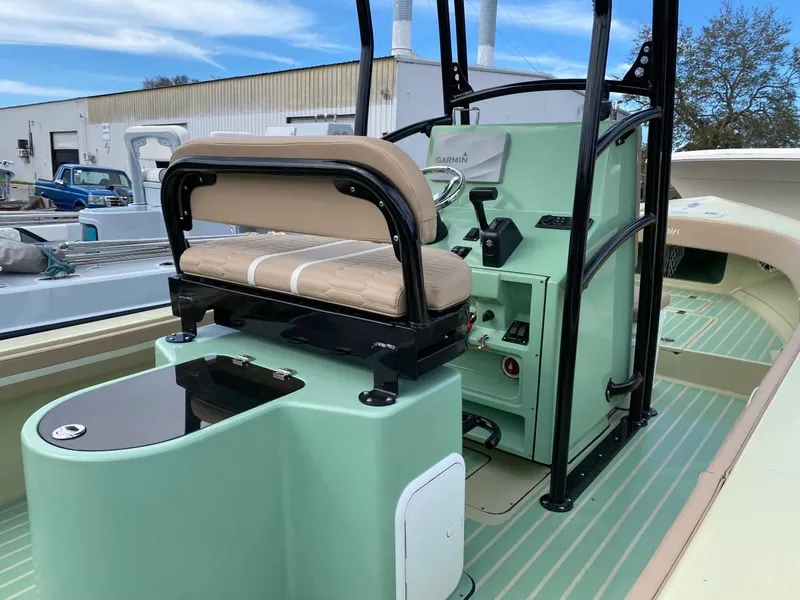 Slide: The Image of 2024 Exuma 22 EXTRA LITE boat interior with mint green console and beige seating. - 5