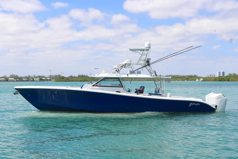 The Image of 2021 Yellowfin 54 Offshore boat on clear blue water under a partly cloudy sky. - 0