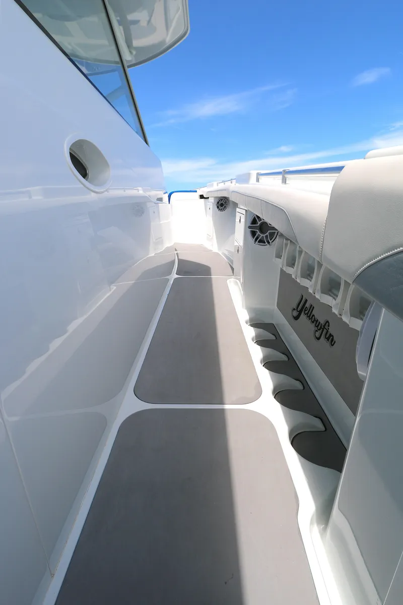 Slide: The Image of 2021 Yellowfin 54 Offshore boat deck with sleek design and clear blue sky. - 12