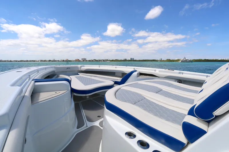 Slide: The Image of 2021 Yellowfin 54 Offshore boat interior with cushioned seating, ocean view, and blue sky. - 14