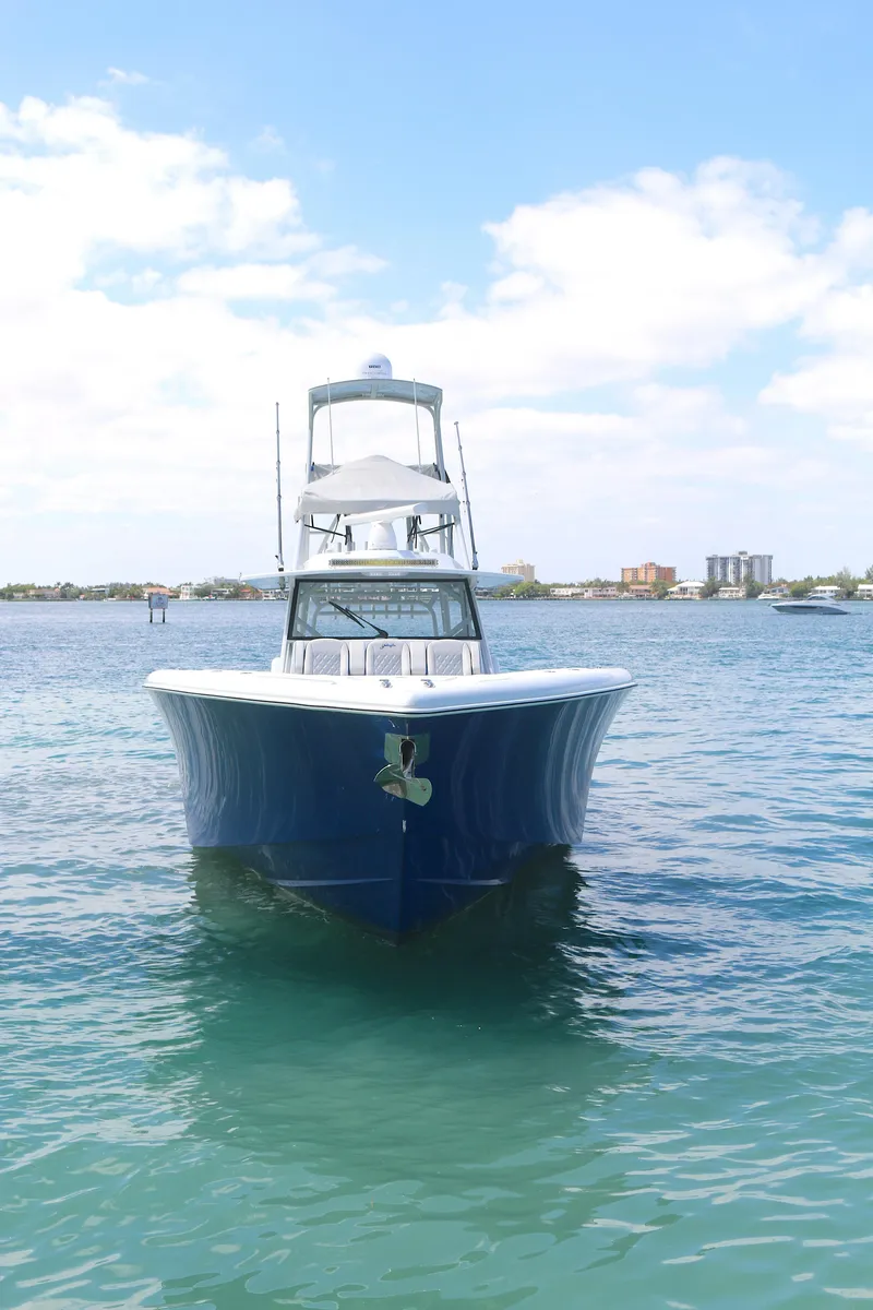 Slide: The Image of 2021 Yellowfin 54 Offshore boat on calm water under a clear sky. - 27