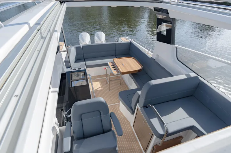 Slide: The Image of 2024 Nimbus Weekender 11 #20 boat interior with seating and table. - 14