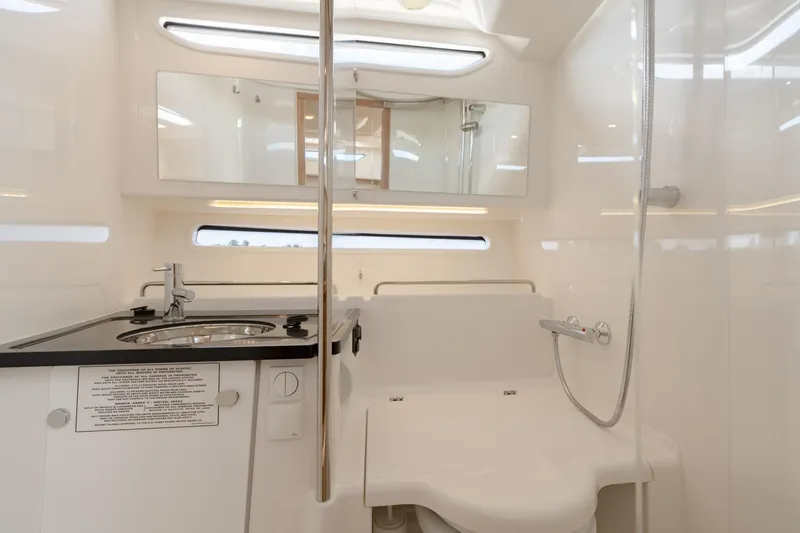 Slide: The Image of Modern bathroom in 2024 Nimbus Weekender 11 #20 boat with sink, mirror, and shower. - 20
