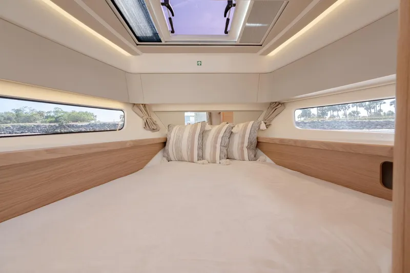 Slide: The Image of Luxurious bedroom interior of 2024 Nimbus Weekender 11 #20 yacht with skylight and side windows. - 21