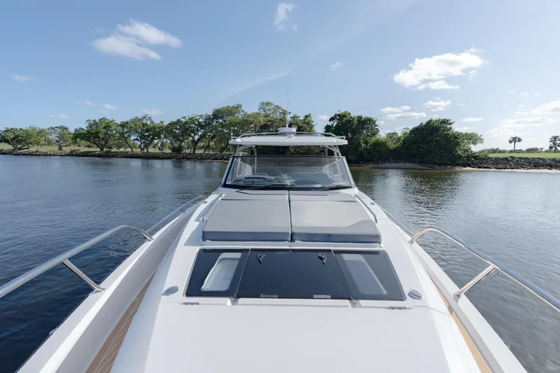 Slide: The Image of 2024 Nimbus Weekender 11 #20 boat on calm water with lush green shoreline. - 4