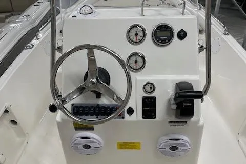 Slide: The Image of 2023 Key West 1720 Center Console boat dashboard with steering wheel and gauges. - 9
