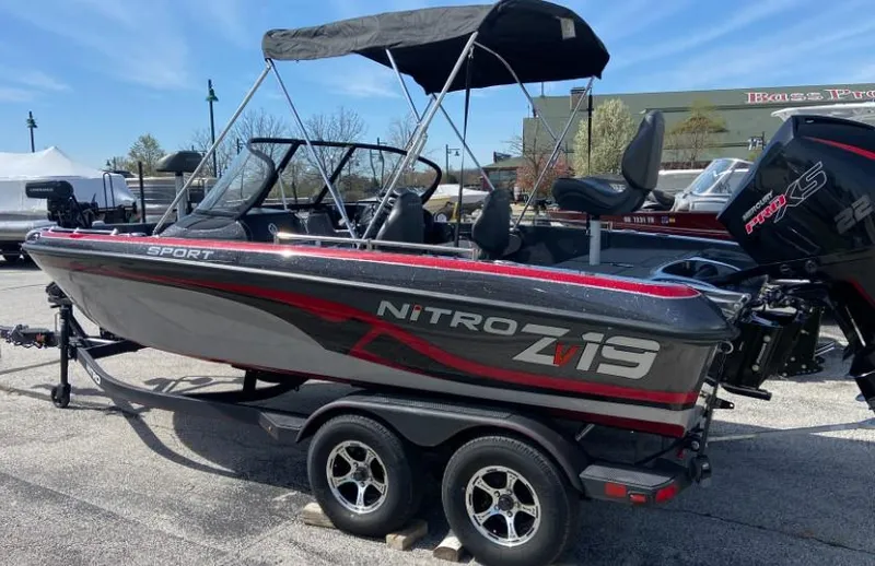 Slide: The Image of 2024 Nitro ZV19 Sport Pro boat on trailer, black and red, outdoor display. - 2