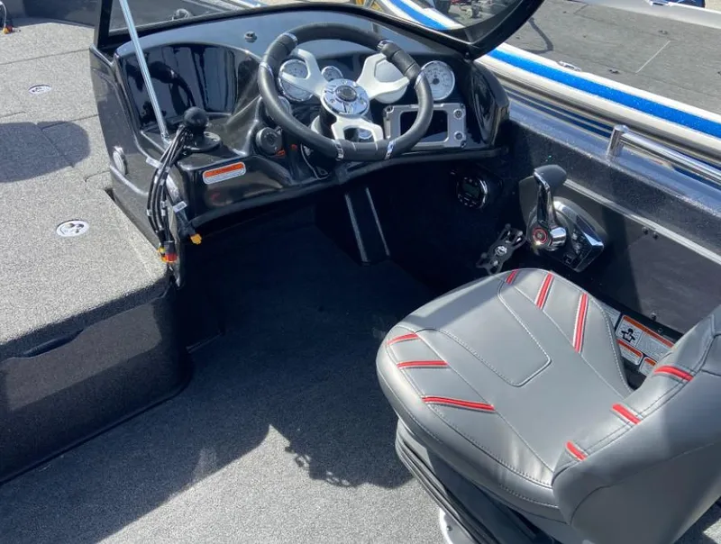 Slide: The Image of 2024 Nitro ZV19 Sport Pro boat cockpit with steering wheel and captain's chair. - 3