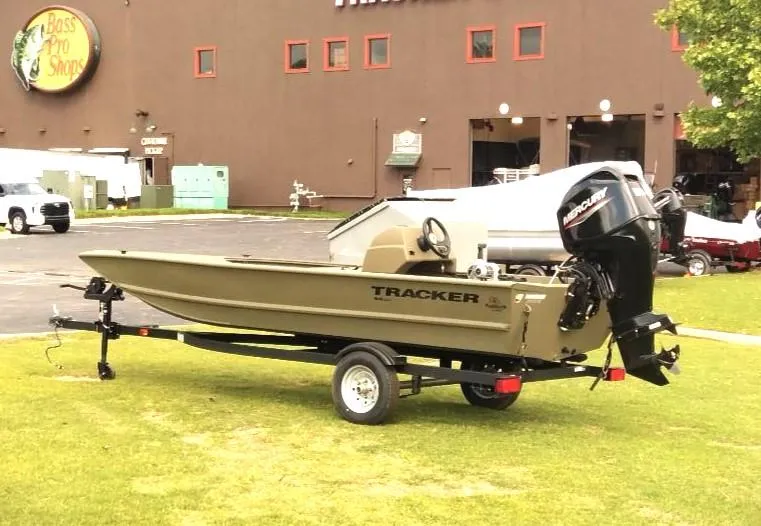 Slide: The Image of 2024 Tracker Grizzly 1648 SC boat on trailer outside Bass Pro Shops. - 3