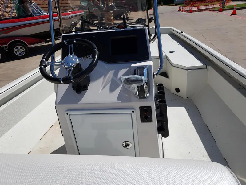 Slide: The Image of 2024 Ranger RB210 boat console with steering wheel and controls. - 2