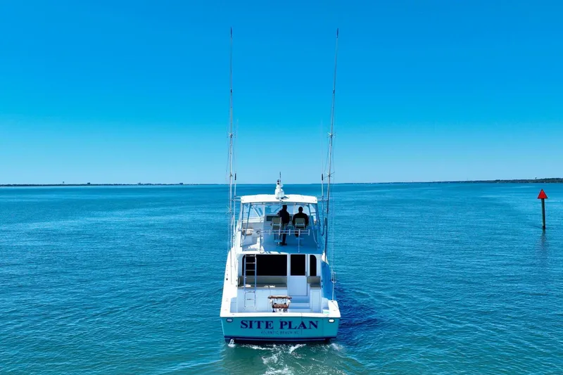Slide: The Image of Viking 55 Convertible yacht cruising on open water, clear blue sky, 2000 model. - 17