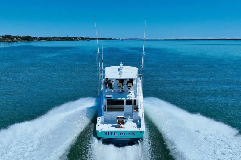 Slide: The Image of 2000 Viking 55 Convertible yacht cruising on open water, rear view. - 20