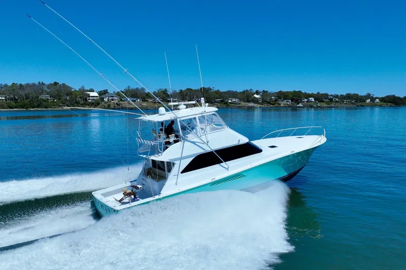 Slide: The Image of 2000 Viking 55 Convertible yacht cruising on a clear blue lake. - 21