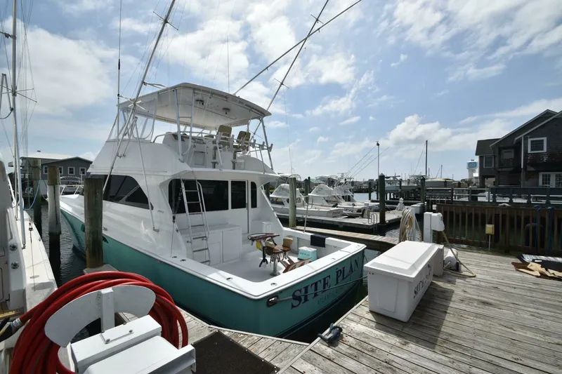 Slide: The Image of 2000 Viking 55 Convertible yacht docked at marina under cloudy sky. - 29