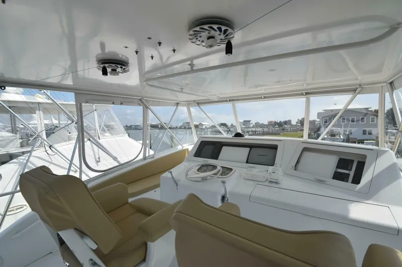 Slide: The Image of Interior view of 2000 Viking 55 Convertible yacht cockpit with beige seats and navigation equipment. - 36
