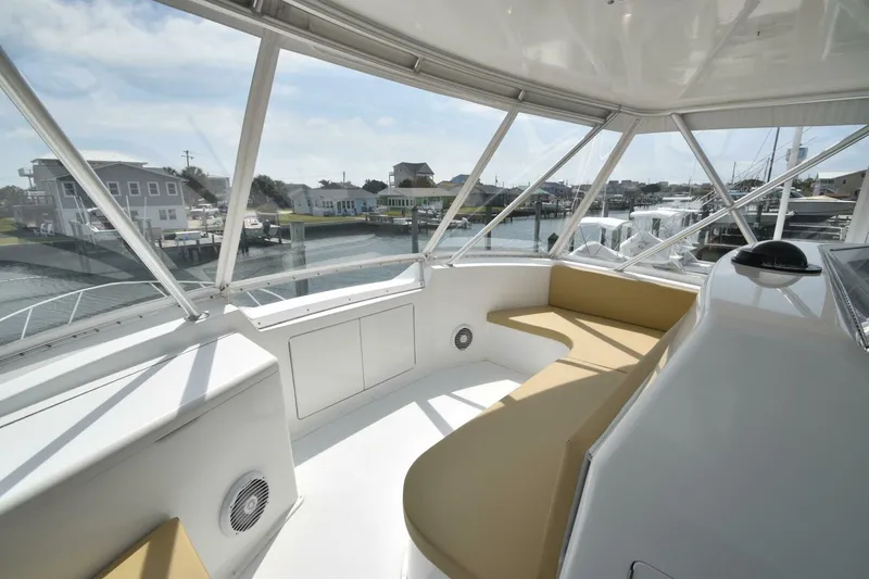 Slide: The Image of Interior view of 2000 Viking 55 Convertible yacht with beige seating and marina backdrop. - 37