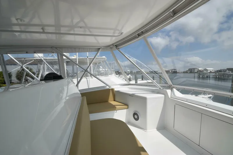 Slide: The Image of Interior view of 2000 Viking 55 Convertible yacht with seating and marina backdrop. - 40