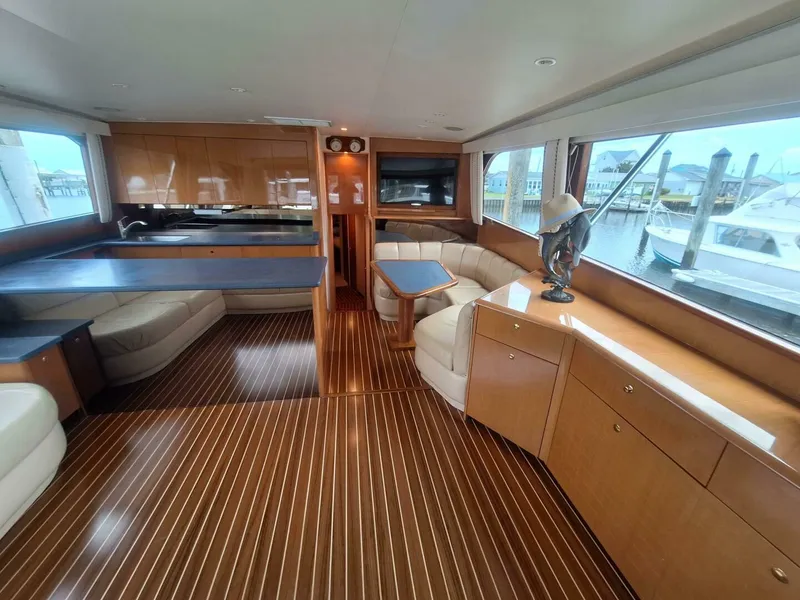 Slide: The Image of Luxurious interior of a 2000 Viking 55 Convertible yacht with elegant wood finishes. - 42