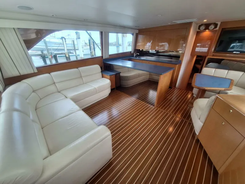 Slide: The Image of Luxurious interior of a 2000 Viking 55 Convertible yacht with leather seating and wood flooring. - 43