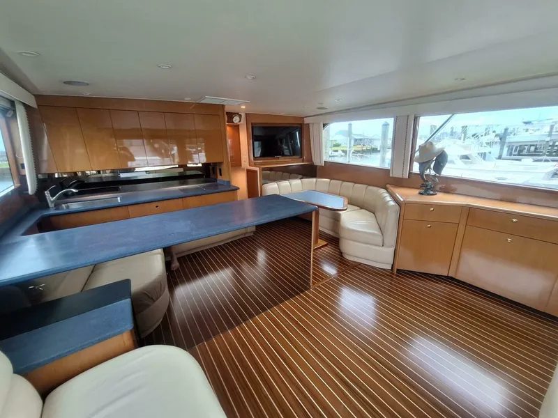 Slide: The Image of Luxurious interior of 2000 Viking 55 Convertible yacht with elegant wood finishes and spacious seating. - 44