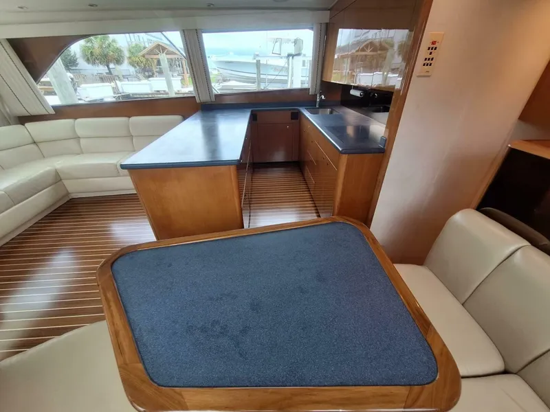 Slide: The Image of Luxurious interior of a 2000 Viking 55 Convertible yacht with modern kitchen and seating area. - 49