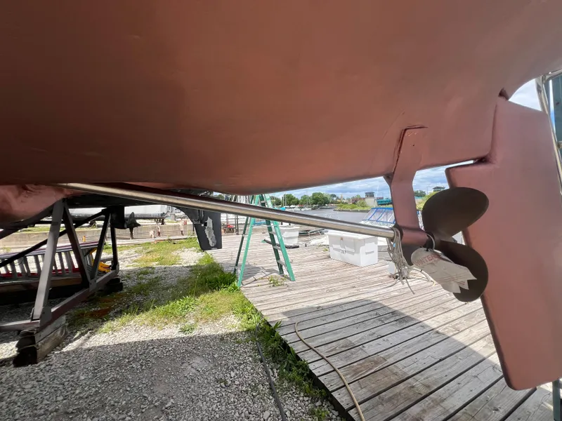 Slide: The Image of 1983 Hunter 27 sailboat propeller and rudder on dry dock. - 17