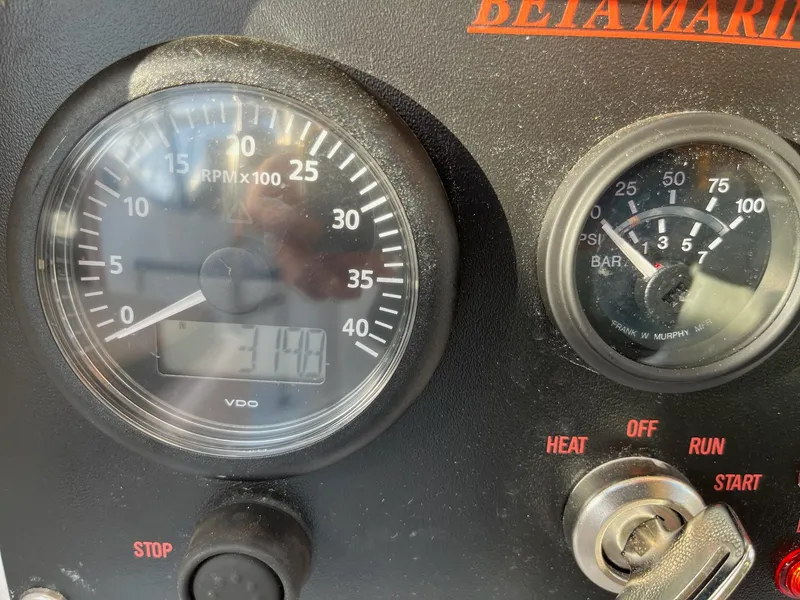 Slide: The Image of Close-up of 1983 Hunter 27 boat engine control panel with RPM and pressure gauges. - 21