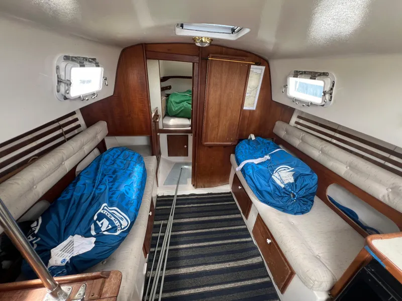 Slide: The Image of Interior of a 1983 Hunter 27 sailboat with sleeping bags on benches. - 22