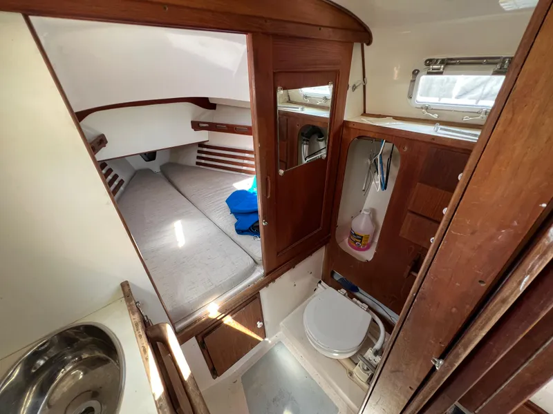 Slide: The Image of 1983 Hunter 27 sailboat interior with sink, storage, and sleeping quarters. - 30
