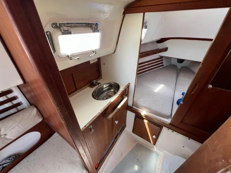 Slide: The Image of Interior cabin of 1983 Hunter 27 sailboat with V-berth and wooden trim. - 31