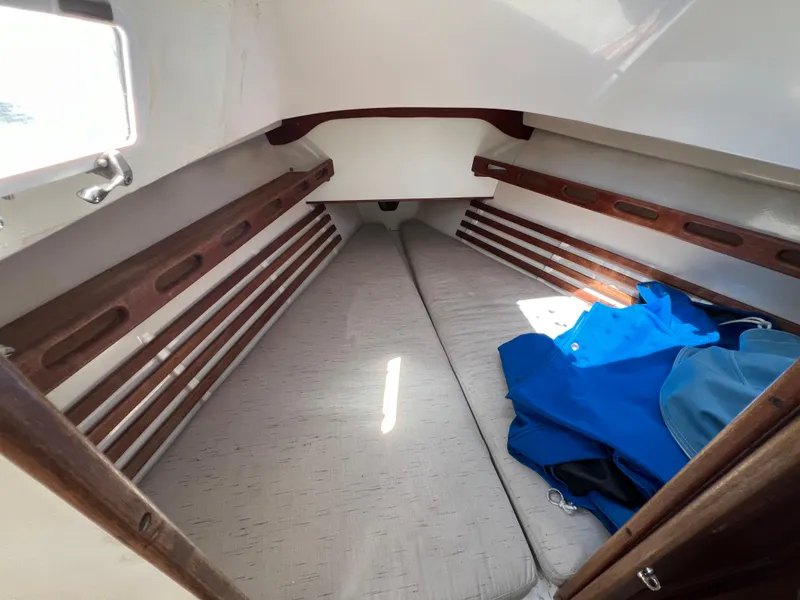 Slide: The Image of 1983 Hunter 27 sailboat in dry dock with protective cover. - 32