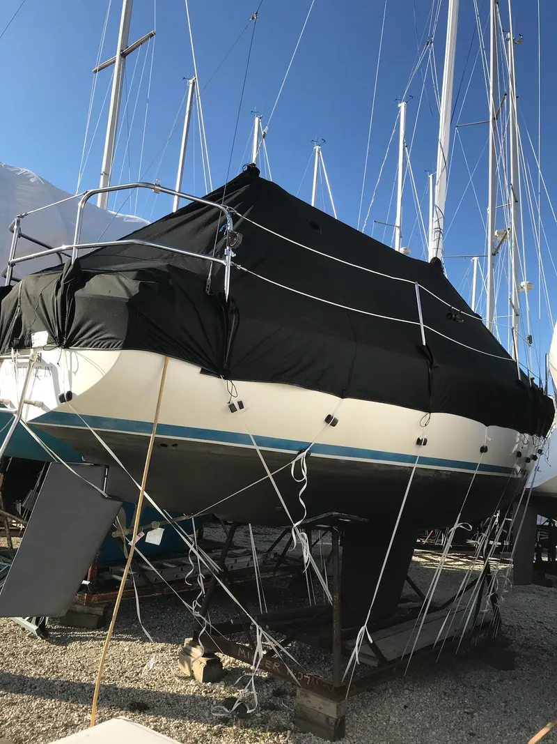 Slide: The Image of Hunter 27 sailboat, 1983 model, docked in a marina with other boats. - 35