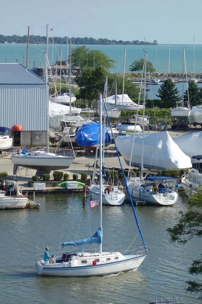 Slide: The Image of 1983 Hunter 27 sailboat on calm blue water. - 36